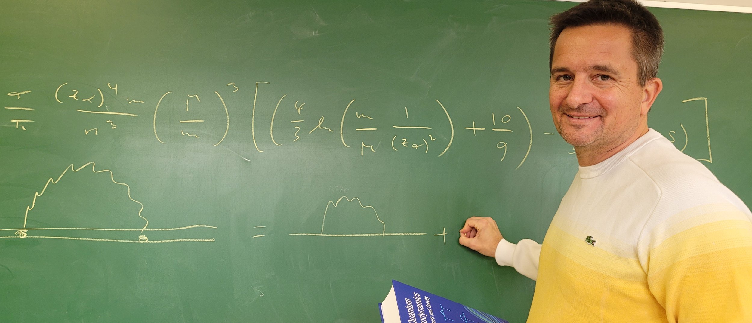 A professor writing a formula on the board